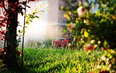 front lawn of a customers sprinklers going off