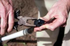 one of our Mukilteo sprinkler repair techs is tightening a pipe